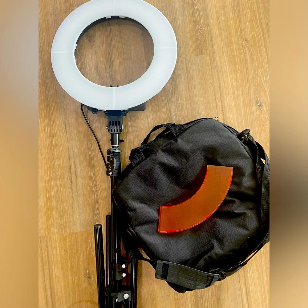 Ring light tripod with camera and phone attachment.